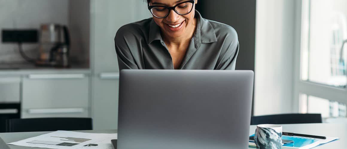 RHB Assets From IGX: A woman sitting at a laptop and checking her credit.