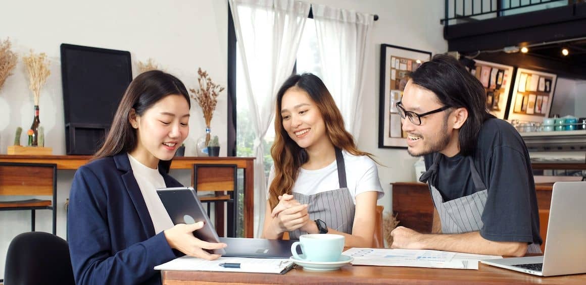 An asian couple discussing their future plans or real estate investment with an agent.