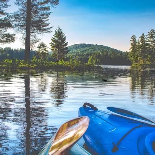 Blue kayak in lake in Vermont.