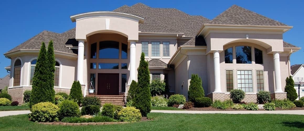 Large house against a bright blue sky.