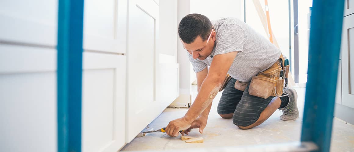 RHB Assets From IGX: Handyman renovating a kitchen, surrounded by tools and ladders.