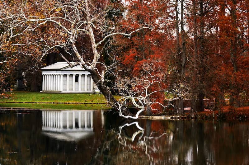 RHB Assets From IGX: Fall reflection in a tranquil pond at a mausoleum.