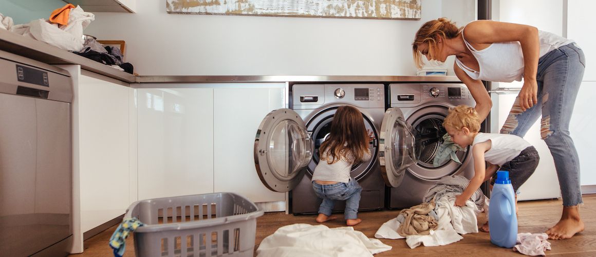 RHB Assets From IGX: Happy family folding clothes together in a laundry room