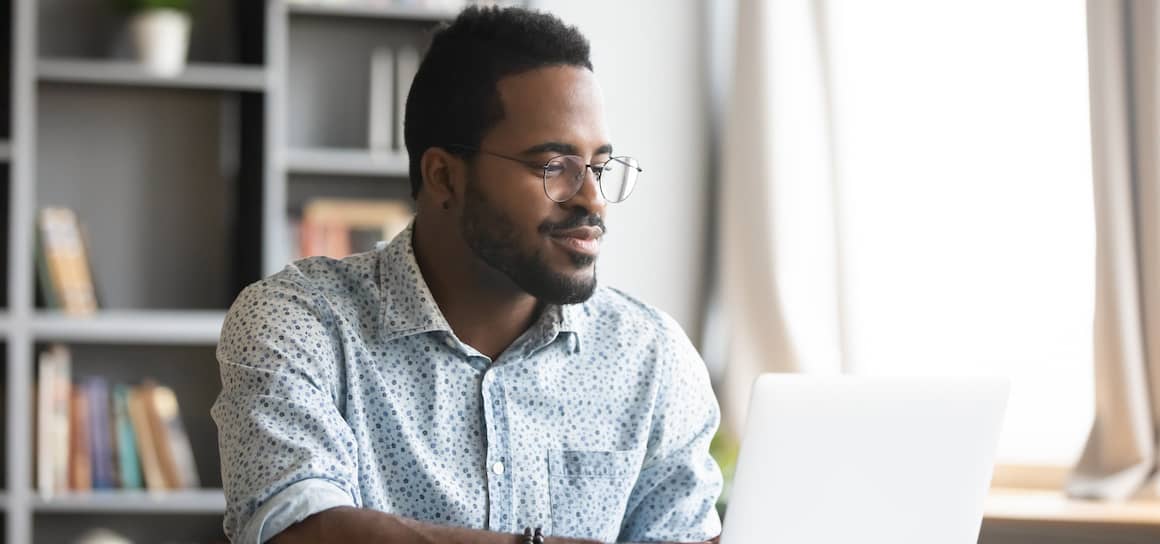 RHB Assets From IGX: Man doing online research on his laptop at home.