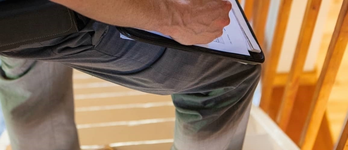 Close-up image of a pest inspection officer holding a clipboard.
