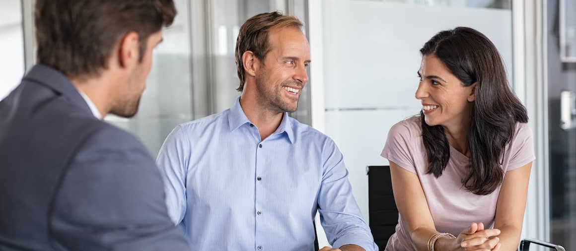 Middle-aged couple close on a house.