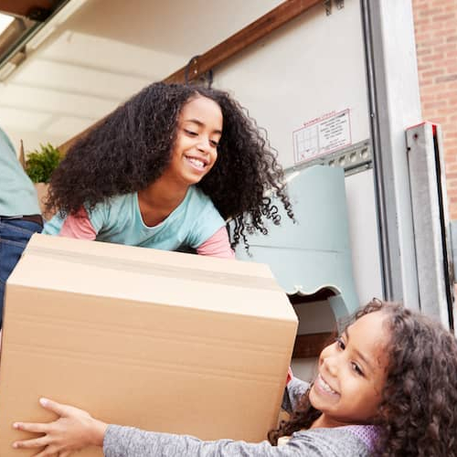 A family moving in, showing a family engaged in the process of moving into a new home.