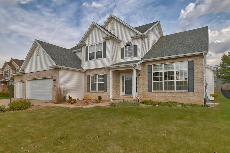 RHB Assets From IGX: Charming suburban home in Champaign with a manicured lawn.