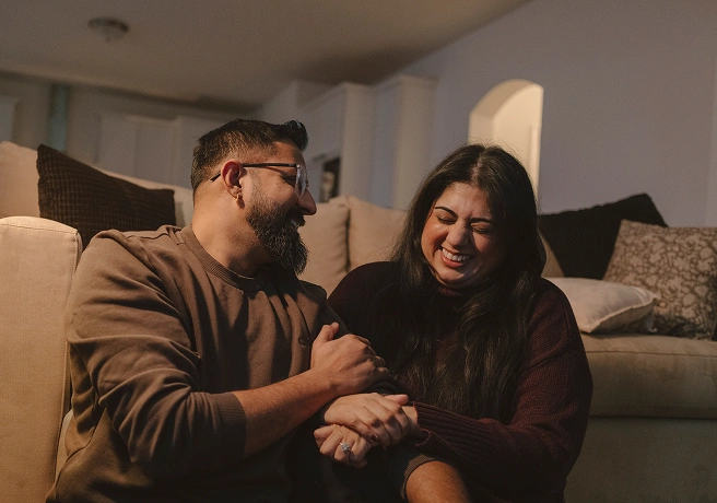 Couple sitting together on a couch at home