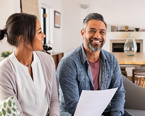 A couple talking with a mortgage lender, potentially in a home buying process.