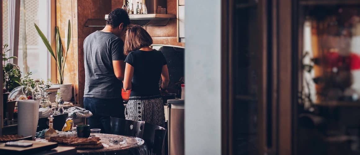 Image of couple cooking breakfast in new home kitchen.