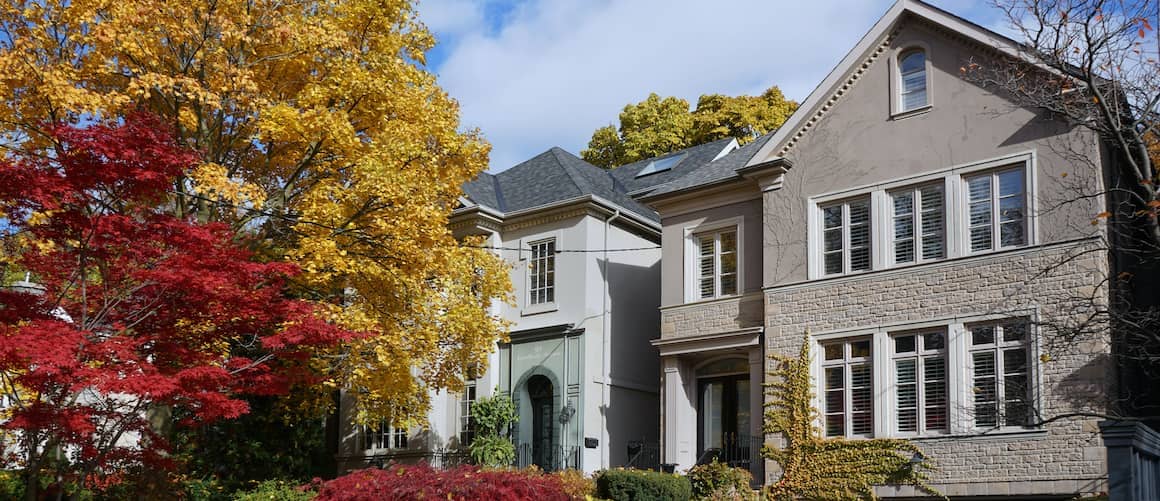 Homes in fall, portraying residential properties during the autumn season with foliage and trees.