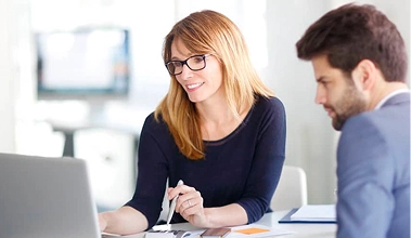 Financial advisor consulting with a client, potentially discussing real estate investments or financial planning