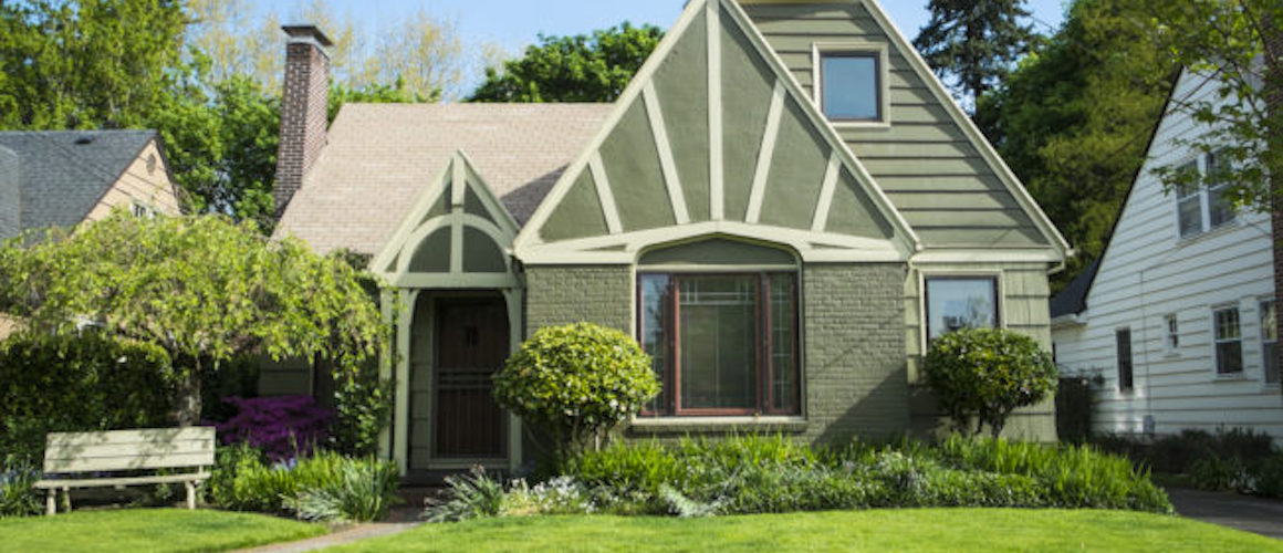 RHB Assets From IGX: Green craftsman-style home with a well-manicured lawn.