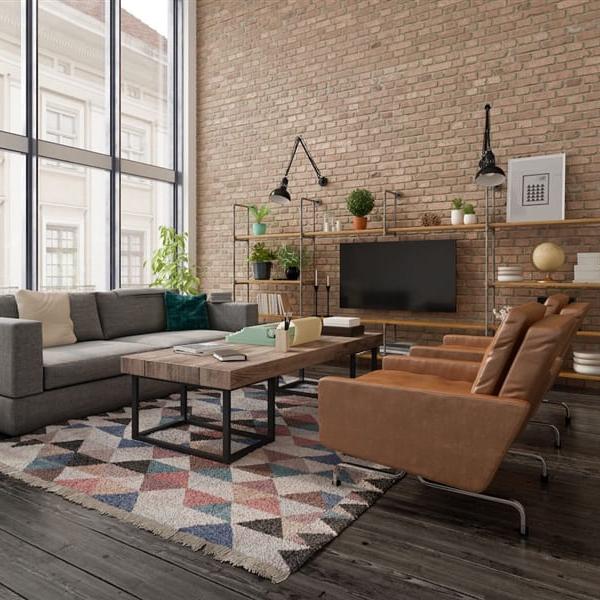 A loft style living room with floor to cieling windows.