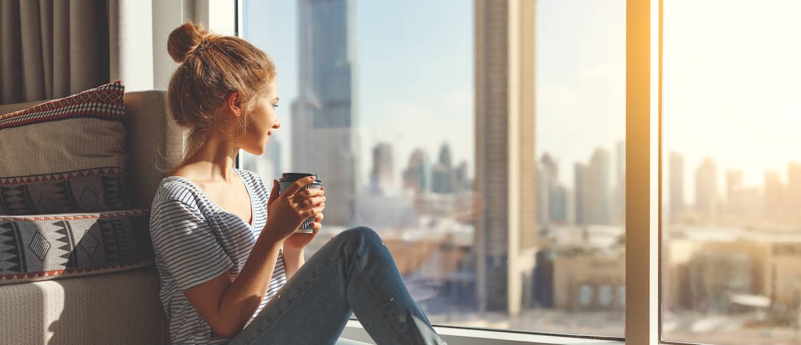 RHB Assets From IGX: Woman paying off debt with a calculator and documents