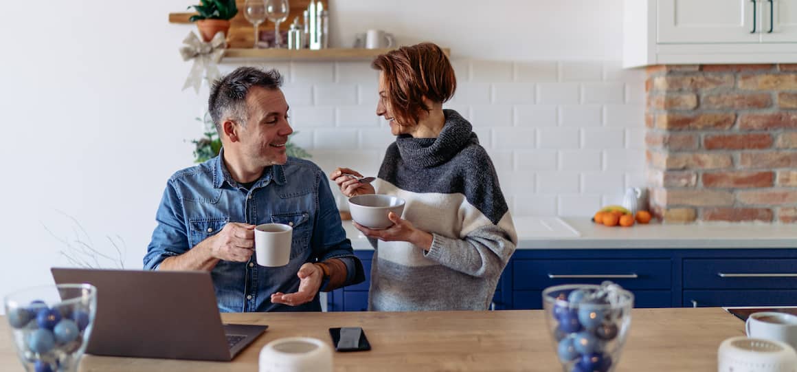 A couple having a conversation over breakfast, potentially discussing financial matters or plans.