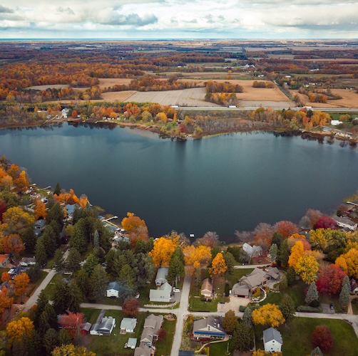 Aerial view of the heart-shaped Saugany Lake in Indiana among fall foliage.,