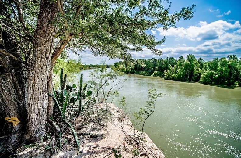 RHB Assets From IGX: Rio Grande river with a bridge and greenery in the background.