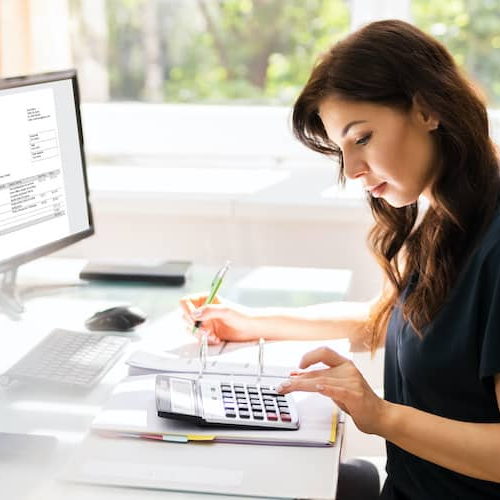 An accountant doing taxes, depicting financial or accounting-related tasks.