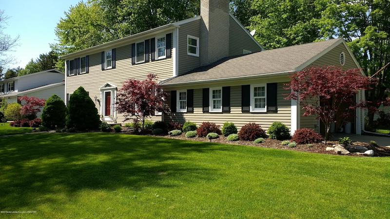 RHB Assets From IGX: Beautiful suburban Okemos house with manicured lawn and trees