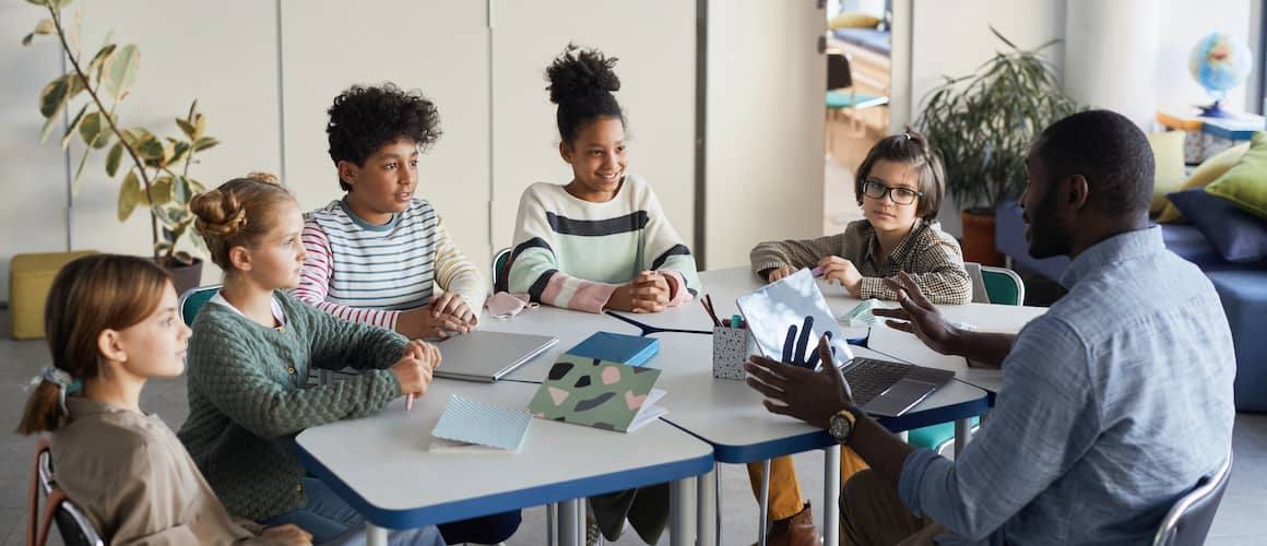 A teacher in a classroom benefiting from home loans.