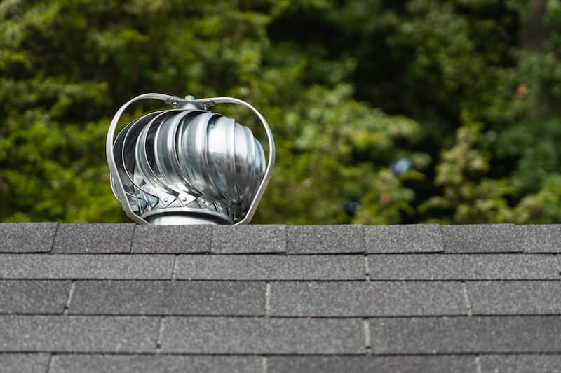 RHB Assets From IGX: Powered exhaust vent on a roof for attic ventilation.