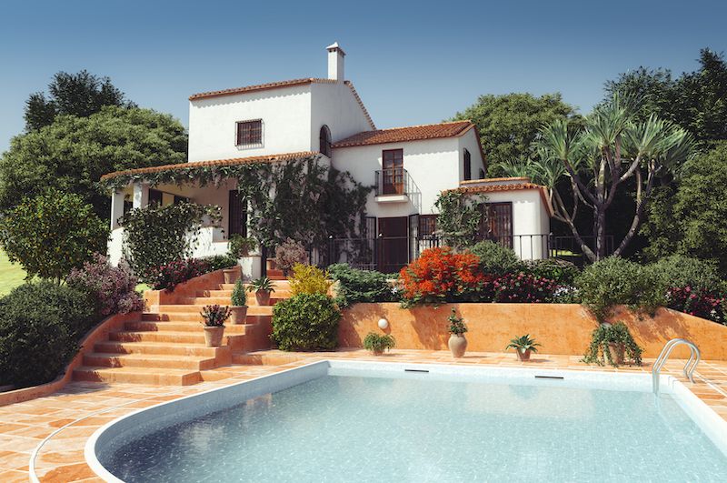 RHB Assets From IGX: Luxury Mediterranean house with a tiled roof and landscaped yard.