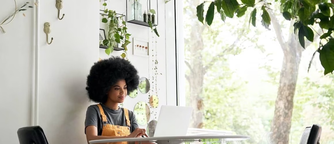 African-American woman looking at credit card.