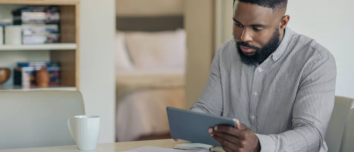 Man working on online banking, indicating financial management or technology use.