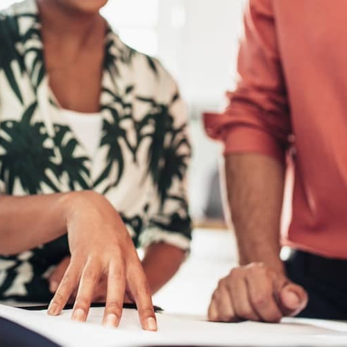 Close up of clients and Realtor reviewing contract.