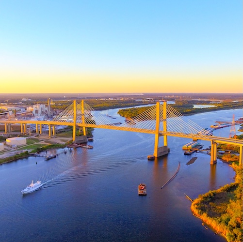 Large bridge over the Mobile river in Alabama with pleasure boats in the water below.