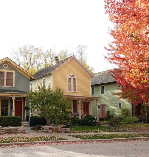 Neighborhood with two story early 1900's colorful homes in autumn.