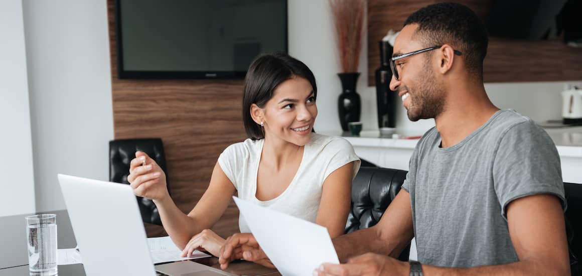 An image showing a couple discussing finances, possibly related to financial planning or discussions.