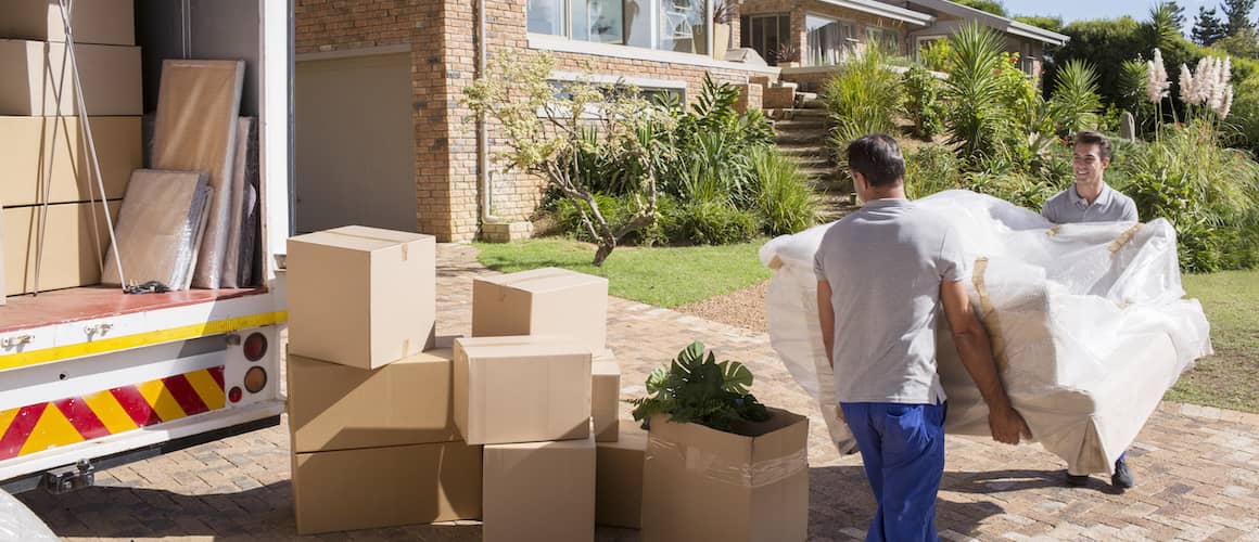 RHB Assets From IGX: Movers carrying a couch outside a house during a move