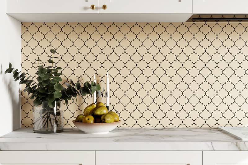 Beige hexagonal backsplash in kitchen with glass vase of dried Eucalyptus on counter.