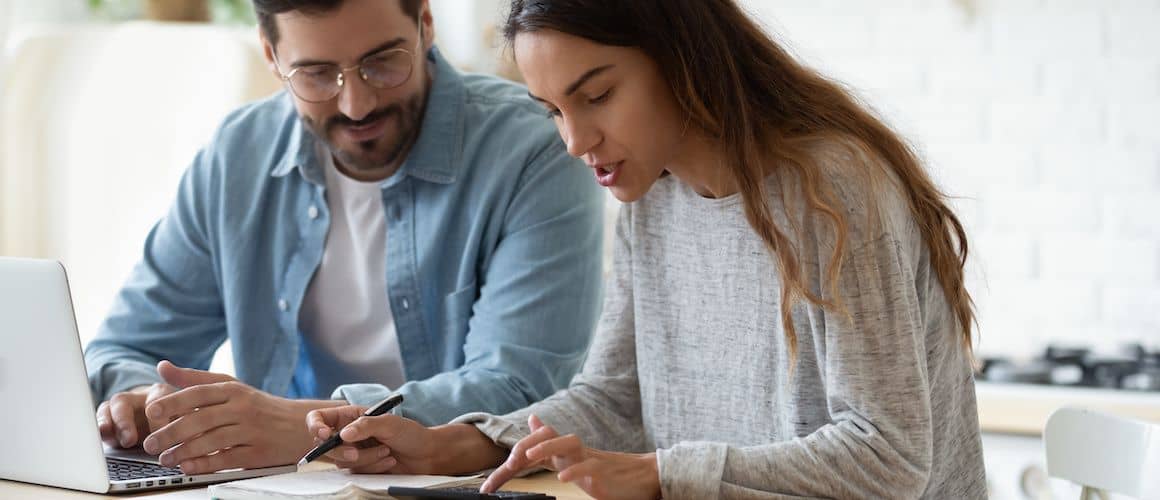 Image of couple filing taxes together.