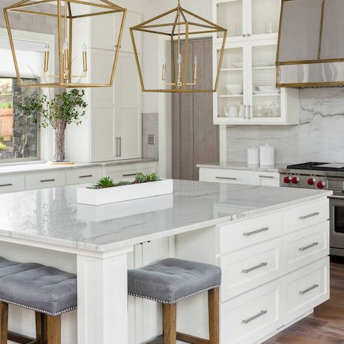 A luxury kitchen with a marble slab backsplash and modern appliances.