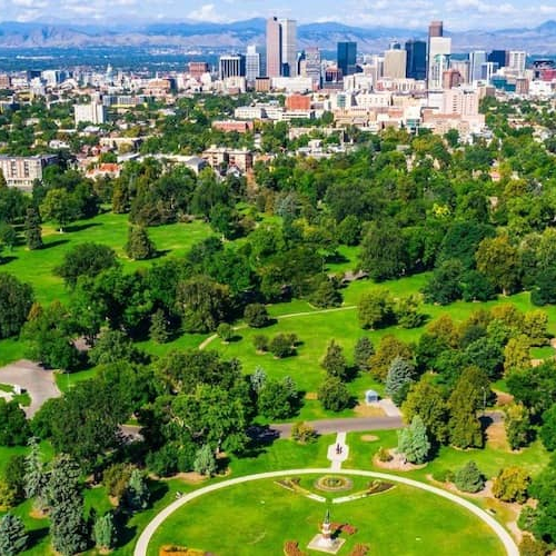 Aerial view of a lush green park near a city.