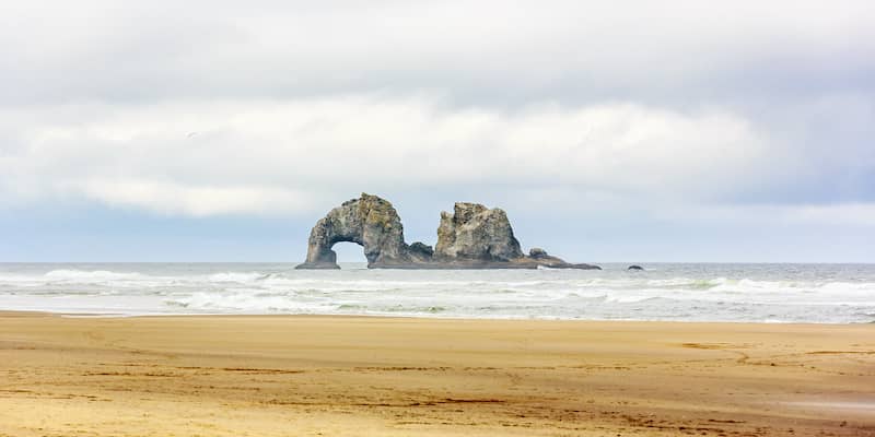 Rock formation in the water at Rockaway Beach in Oregon.