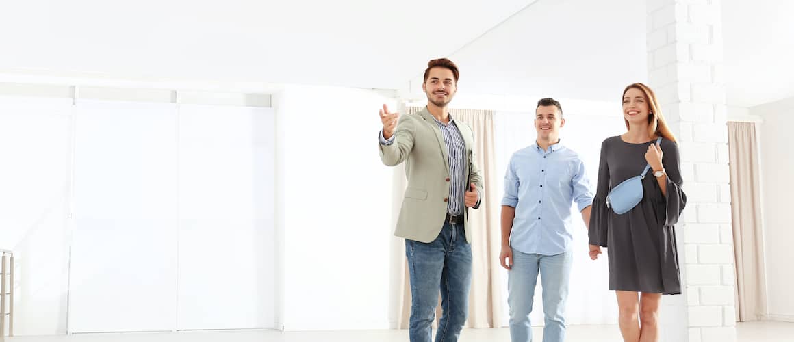 A young couple inspecting a house, potentially considering it for purchase.