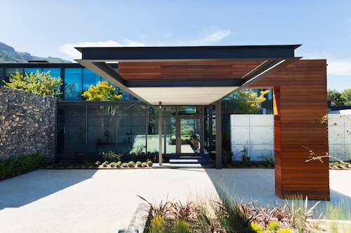 Contemporary minimalistic home with interest architectural details and xeroscape landscape.