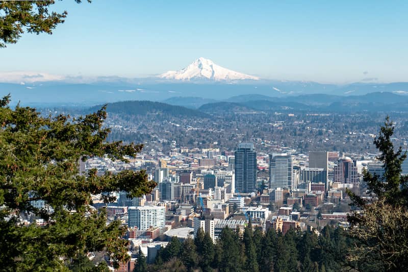 RHB Assets From IGX: Portland, Oregon cityscape with a bridge and waterfront at dusk.