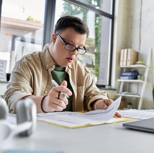 Young man filling out paperwork, possibly for mortgage prequalifiastion.