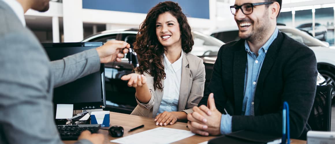 Couple purchasing a car with keys