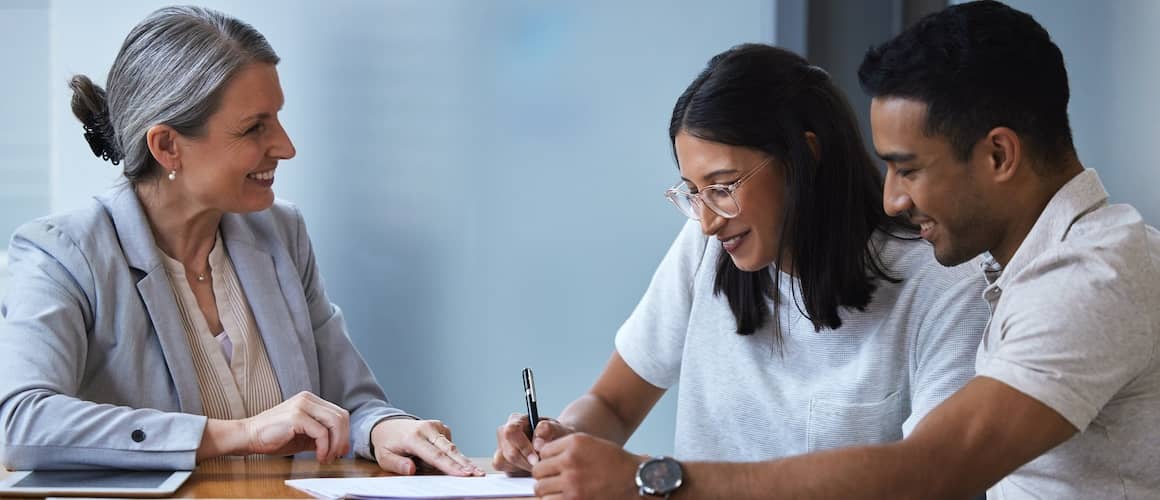 Couple signing auto loan documents.