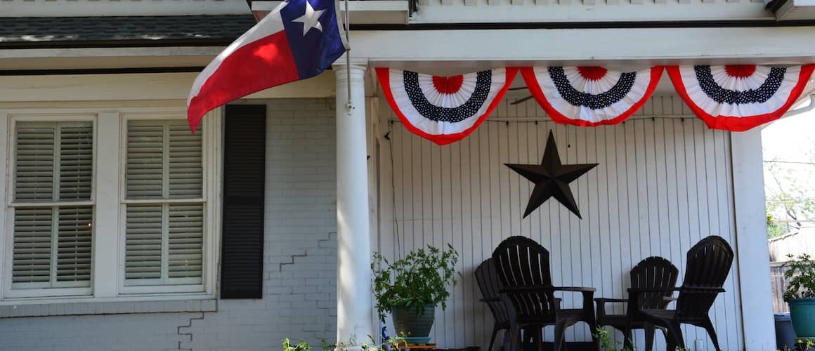 Home with Texas state flag hanging above the porch.