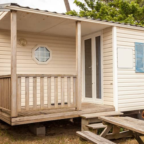 Stock image displaying a mobile home at a camping site, showcasing vacation living or mobile home lifestyle.