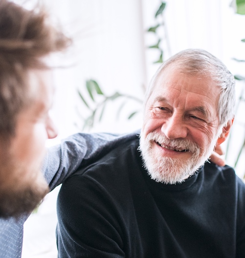 Young man talking to his older father.
