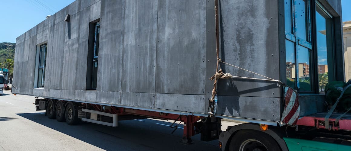 A modular home on a semi-truck, showcasing the transportation of a modular house.